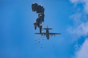 A plane drops humanitarian aid loaded with food supplies to displaced Palestinians at the Nuseirat area of the central Gaza Strip, August 8, 2025. Photo by Ali Hassan/Flash90