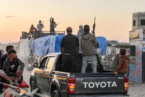 Armed Palestinians seen secure trucks loaded with Humanitarian Aid entering Gaza through the Israeli Kerem Shalom Crossing, in Khan Yunis, in the southern Gaza Strip, September 19, 2025. Photo by Saeed Mohammed/Flash90