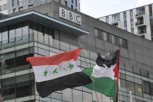 Pro-Palestinian protesters wave flags outside the BBC building at Media City in Salford, October 21, 2023. (Photo: Shutterstock)