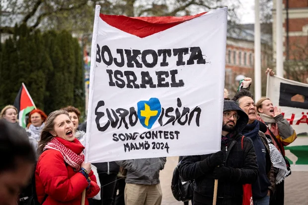 People hold a banner at a demonstration in connection with the municipal board's consideration of a citizens' proposal by the initiative 'No Eurovision in Malmo with Israel's participation' to stop Israel's participation in Eurovision, outside the City Hall in Malmo, Sweden, April 10, 2024 (Photo: Johan NilssonTT News Agency/via REUTERS).