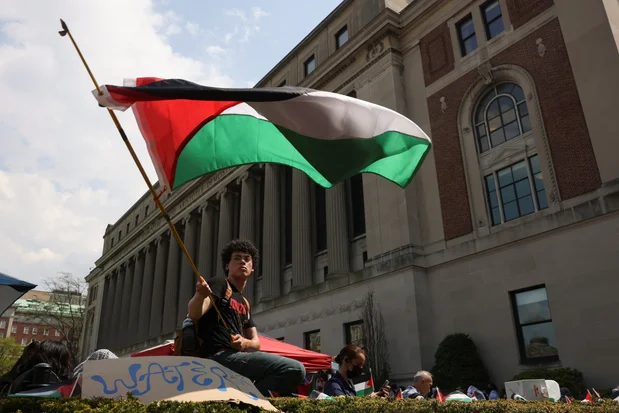A student waves a flag during a march on Columbia University campus in support of a protest encampment supporting Palestinians, despite a 2pm deadline issued by university officials to disband or face suspension, during the ongoing conflict between Israel and the Palestinian Islamist group Hamas, in New York City, U.S., April 29, 2024. Photo: Reuters by Caitlin Ochs