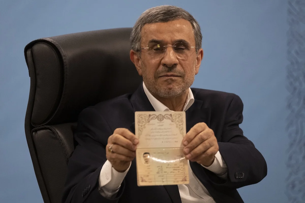 Former Iranian President Mahmoud Ahmadinejad is showing his identification to the media while attending a registration hall in the Iranian Interior Ministry building for registering as a presidential elections
