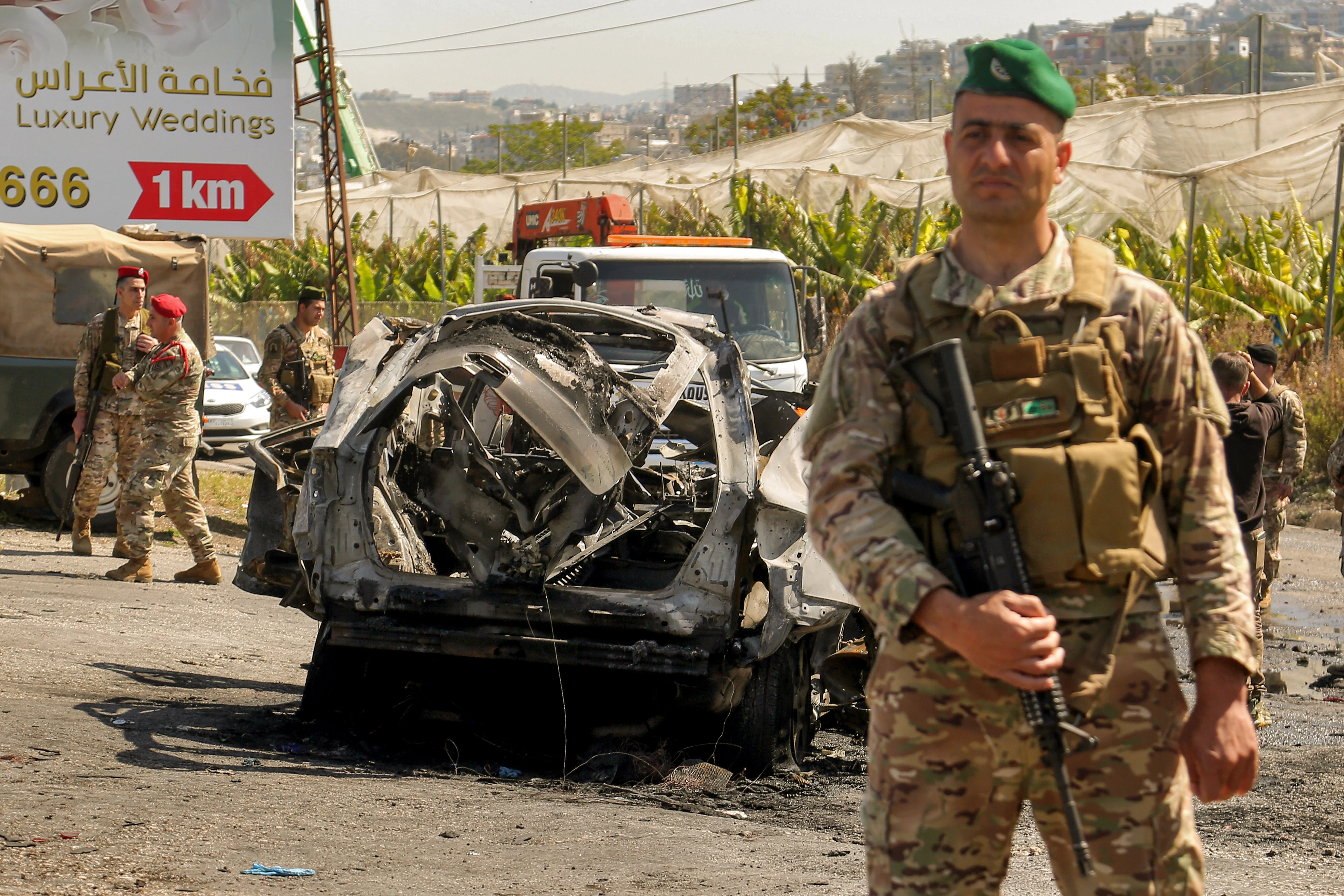 Lebanese soldiers secure the area where a SUV reportedly hit by an Israeli strike in Ghaziyeh, near the southern port city Sidon. Reuters