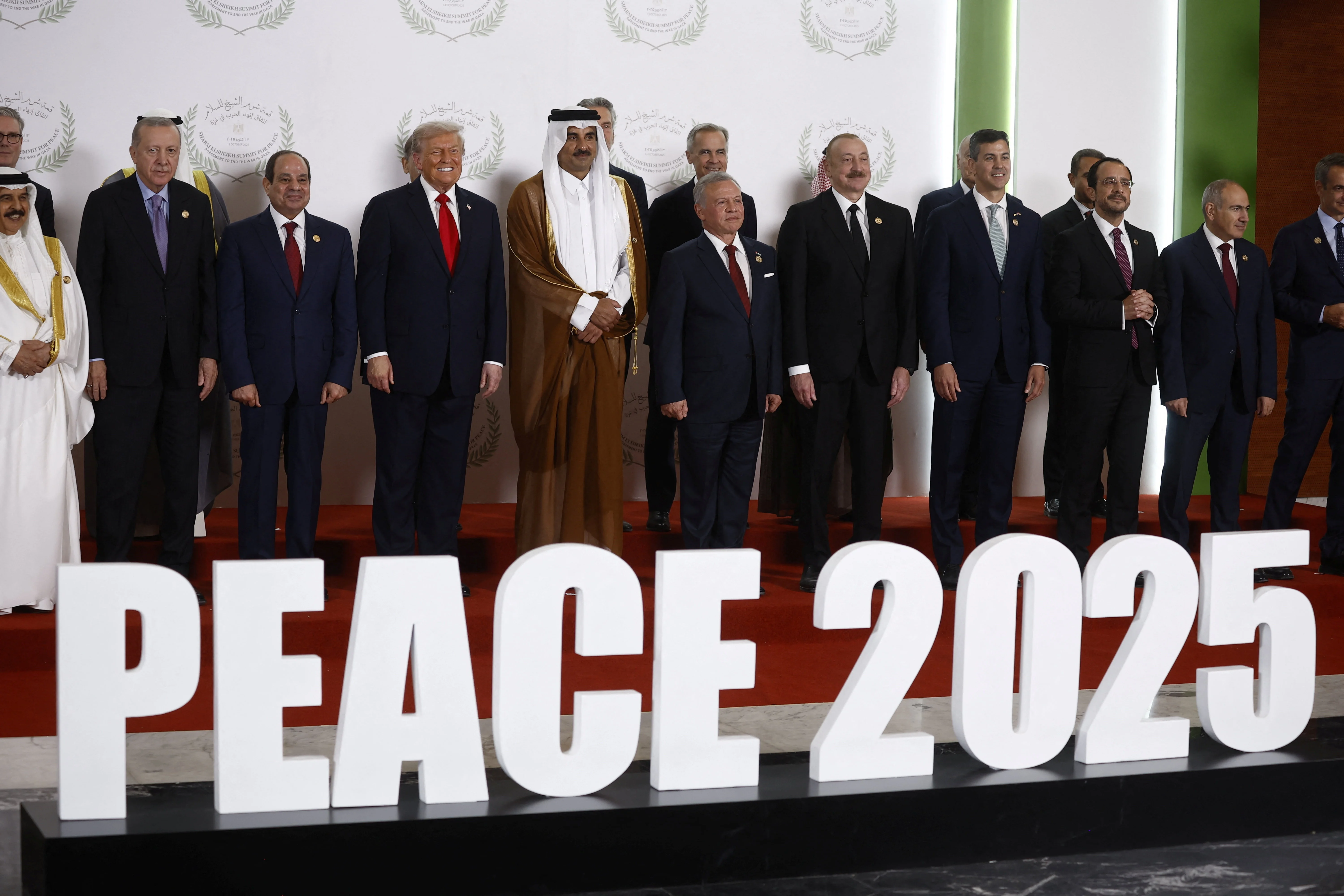 World leaders including U.S. President Donald Trump and Egypt's President Abdel Fattah al-Sisi pose for a family photo, at a world leaders' summit on ending the Gaza war, amid a U.S.-brokered prisoner-hostage swap and ceasefire deal between Israel and Hamas, in Sharm el-Sheikh, Egypt, October 13, 2025 Photo; Reuters Connect by Yoan Valat
