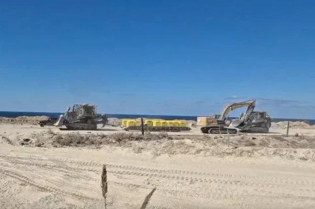 A screengrab from a handout video shows Israeli military vehicles moving barrier blocks to mark the 