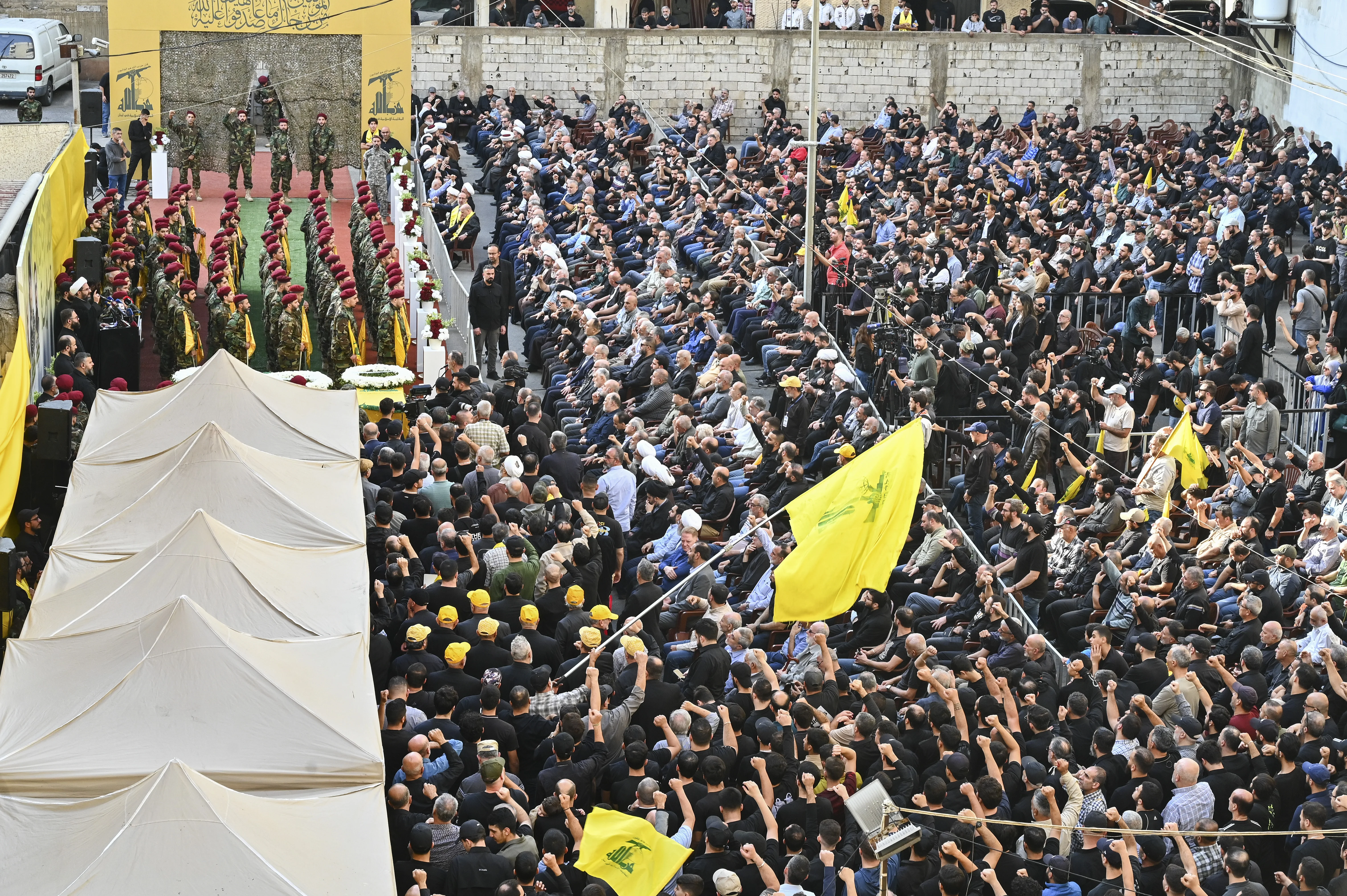 Hezbollah members carry a coffin while chanting political slogans during the funeral procession in Beirut, Lebanon, on November 24, 2025. (Photo via Reuters).