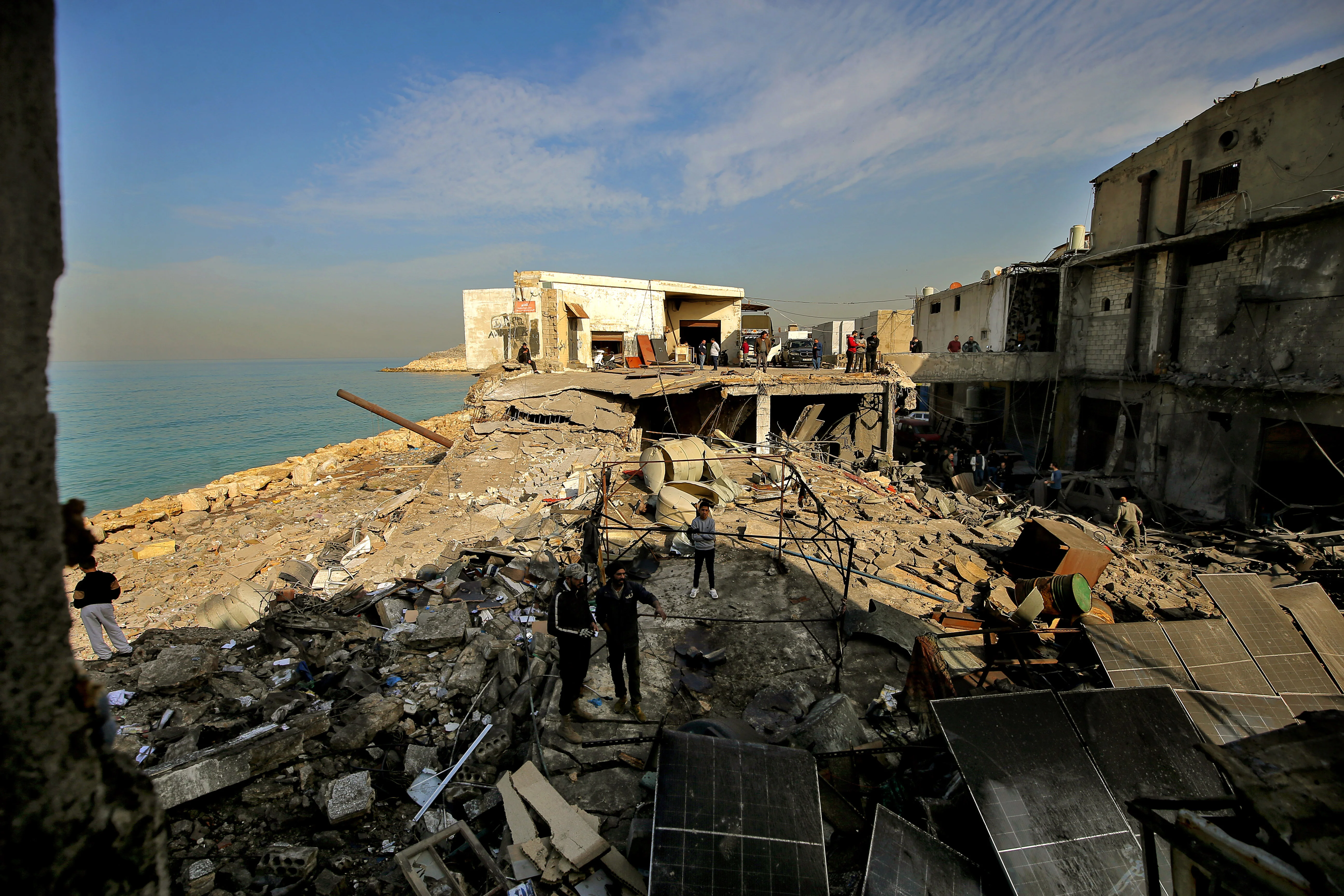 People inspect damage caused by an overnight Israeli air raid in the industrial area of Ghazieh on the outskirts of the southern Lebanese port city of Sidon. Israeli military launched strikes on southern and eastern parts Lebanon after warning it would hit what it called pro-Iranian Hezbollah and Palestinian Hamas targets, January 6, 2026 Photo: Marwan Naamani/ZUMA Press Wire via Reuters Connect