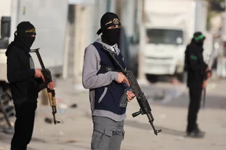 Militants from Hamas and Palestinian Islamic Jihad stand on a street during Eid al-Fitr in Gaza City, March 20, 2026. (Photo: REUTERS/Dawoud Abu Alkas)