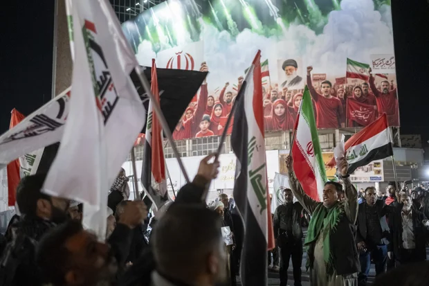 An Iraqi Hashd Shaabi (Popular Mobilization Forces - PMF) member waves an Iranian national flag and shouts slogans in support of new Supreme Leader Ayatollah Mojtaba Khamenei during a pro-government rally in downtown Tehran, Iran, on April 6, 2026, amid ongoing United States-Israeli military operations in the country. (Photo via Reuters)