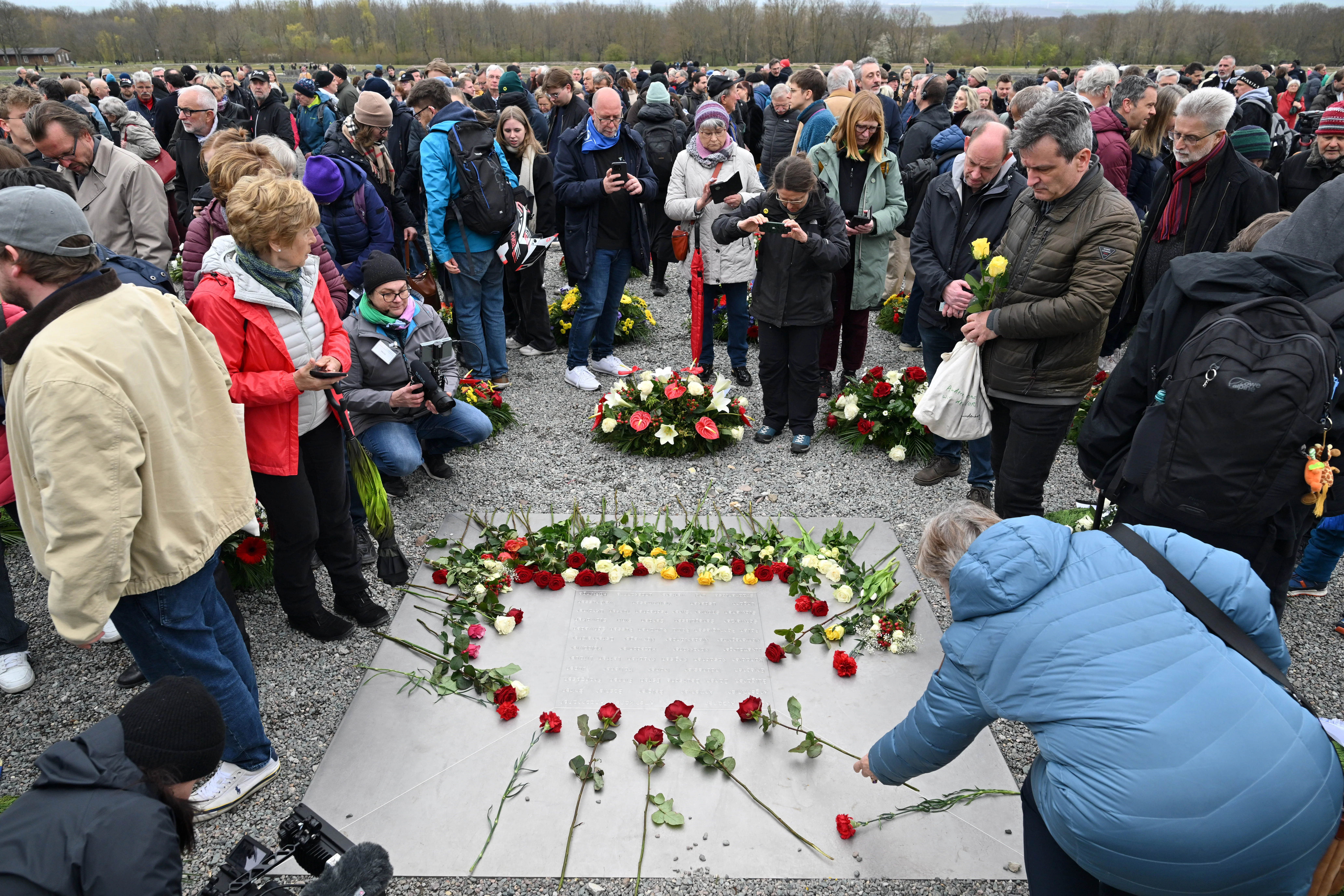 Flowers are laid on a memorial plaque