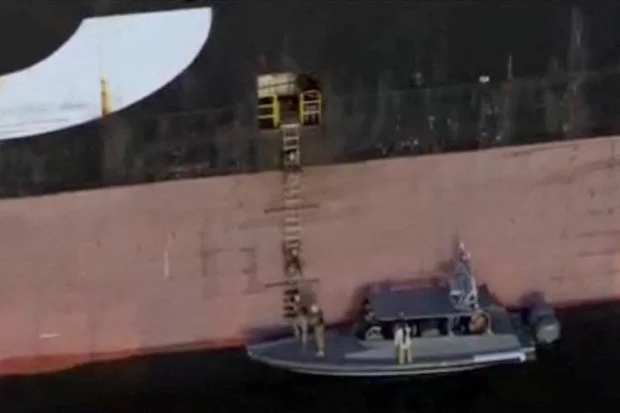A screen capture from a video said to show the seizure of the container ships MSC Francesca and Epaminondas in the Strait of Hormuz, broadcasted on Iranian State TV, and released April 22, 2026, shows soldiers taking part in the operation. (Photo: IRIB/Handout via REUTERS)