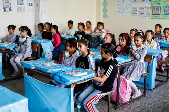 Palestinian students attend their first day of the new school year at an UNRWA school, in Nuseirat
