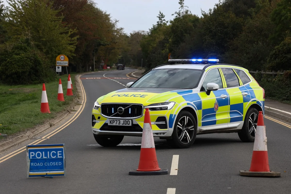 Police officers block a road near the RAF Fairford airbase after police declared a major incident at the base after several men were arrested on suspicion of offenses under the Explosives Act