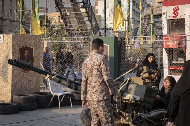 An Iranian Army serviceman demonstrates the operation of an anti-aircraft gun to female members of Iran's ''self-sacrificing'' forces during military training at a city-square training camp in downtown Tehran, Iran, on October 12, 2026. (Photo: Morteza Nikoubazl/NurPhoto)