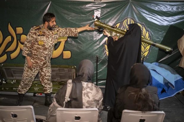 A female member of Iran's ''self-sacrificing'' forces holds a simulator for the Iran-made, man-portable infrared-guided surface-to-air missile Misagh-2 during weapons training at a city-square training camp in downtown Tehran, Iran, October 12, 2026. (Photo: Morteza Nikoubazl/NurPhoto iva Reuters)