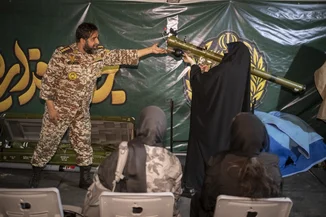 A female member of Iran's ''self-sacrificing'' forces holds a simulator for the Iran-made, man-portable infrared-guided surface-to-air missile Misagh-2 during weapons training at a city-square training camp in downtown Tehran, Iran, October 12, 2026. (Photo: Morteza Nikoubazl/NurPhoto iva Reuters)