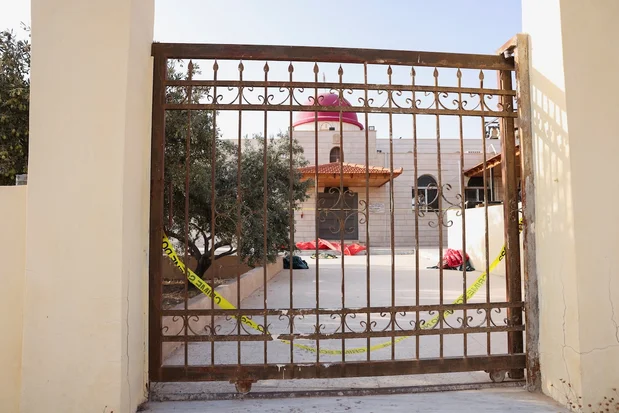 The gate of Saint George’s Greek Orthodox Church, where gunmen opened fire during a funeral the previous day, in the village of Hamoud, Karak, Jordan, October 24, 2026. (Photo: REUTERS/Alaa Al Sukhni)