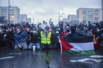 Demonstrators gather behind a Palestinian flag in Paris, France on October 24