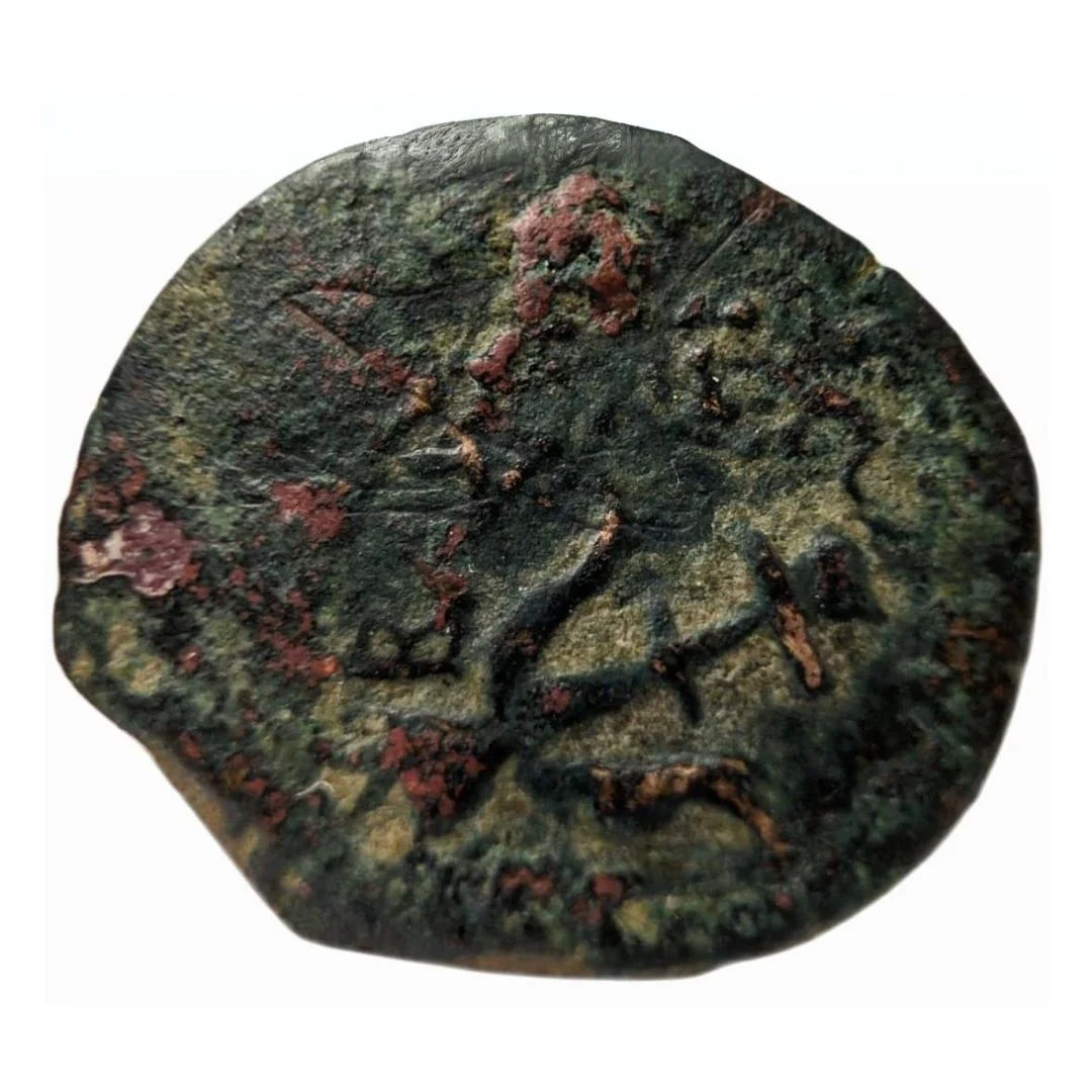 Reverse of a 2000 years old widow's mite coin, showing an anchor, found by a 11 years old child, February, 2024 (photo: Israel Antiquities Authority)