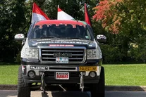 Customized GMC pickup truck covered in Palestinian flags