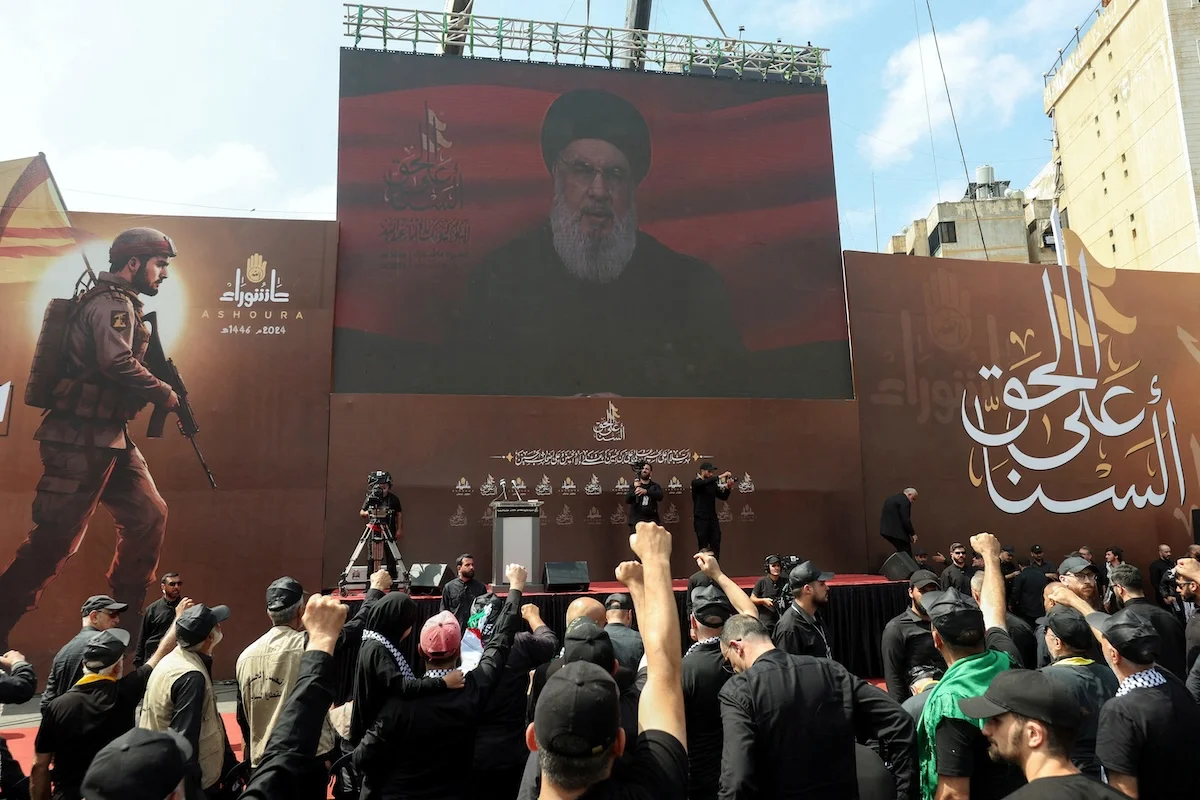 Lebanon's Hezbollah leader Hassan Nasrallah appears on a screen as he addresses his supporters during a religious procession to mark Ashura in Beirut's southern suburbs, Lebanon July 17, 2024. (Photo: REUTERS/Aziz Taher)