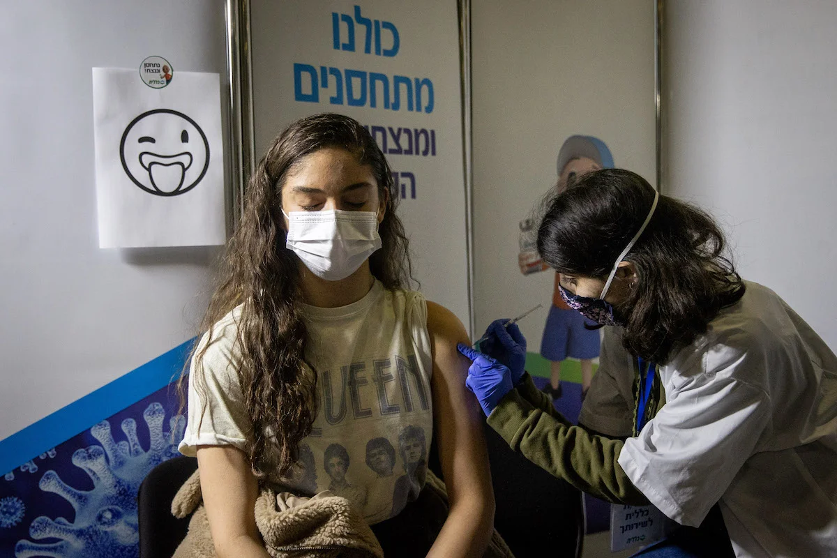 Young Israelis receives a Covid-19 vaccine injection, at Clalit Covid-19 vaccination center in Jerusalem, on February 4, 2021. Photo by Yonatan Sindel/Flash90