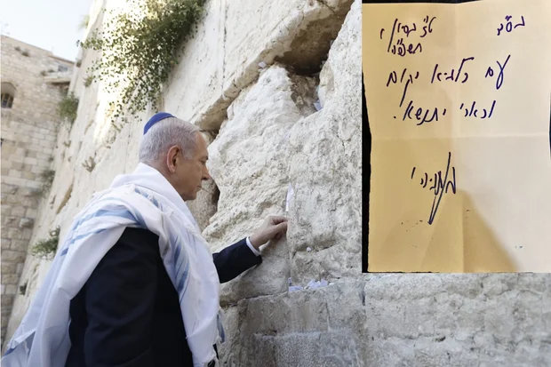 Israeli Prime Minister places a note in the Western Wall that reads 