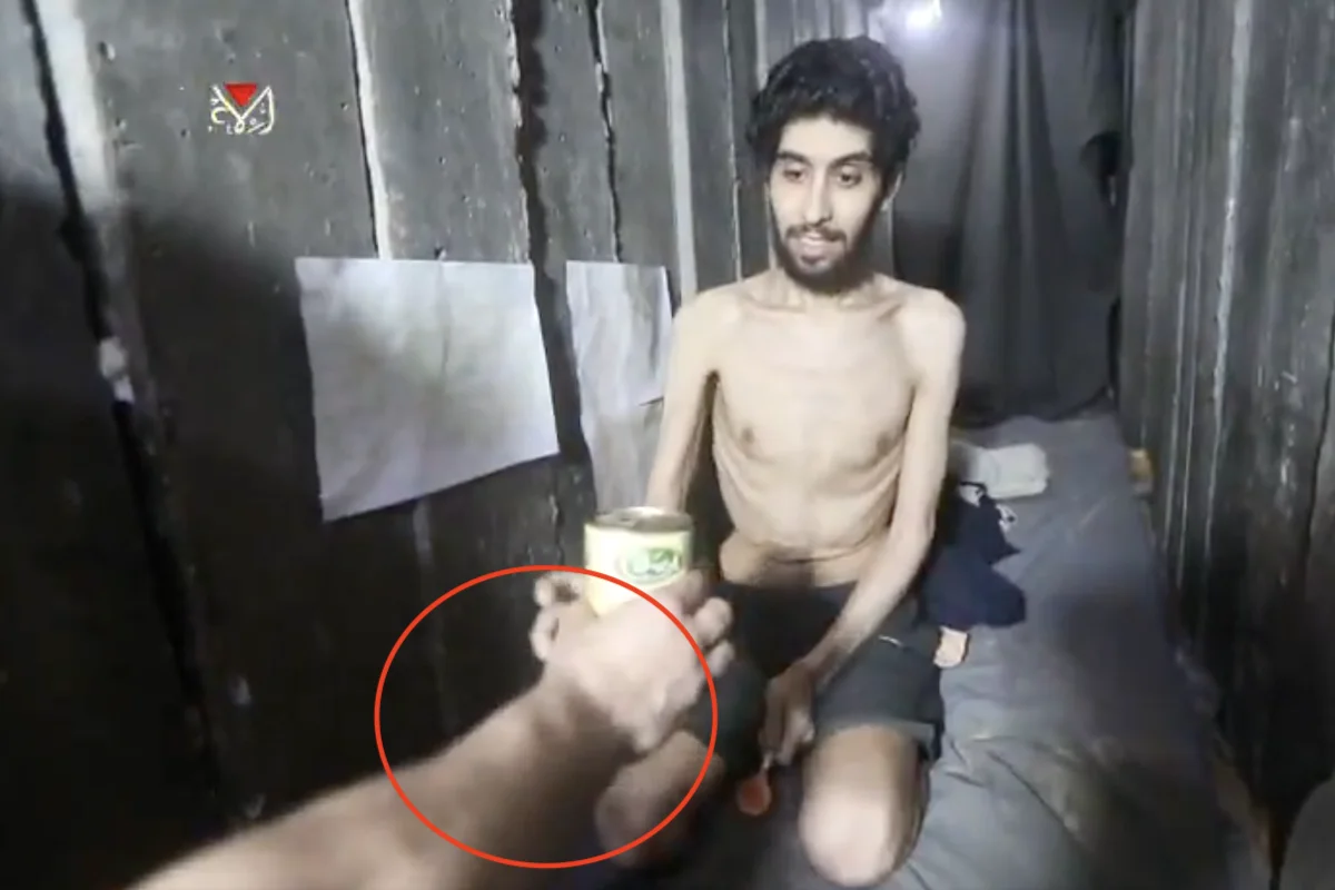 Evyatar David Israeli hostage handed a can of food by well fed Hamas terrorist. August 2 2025. Photo: (Photo used under section 27A of the copyright law)