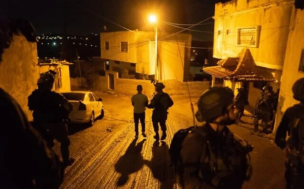 Israeli soldiers arrests a terror suspect thought to be involved in a major Hamas cell planning attacks on Israeli targets in the West Bank and Jerusalem. (Photo: Israel Defense Forces)
