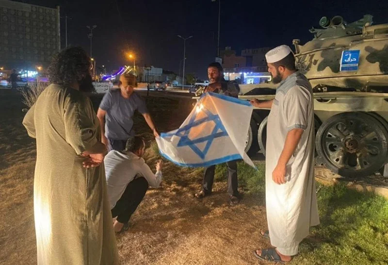 Libyan protesters burn the Israeli flag in Al-Zawiya, Aug. 28, 2023 (Photo: Social Media)