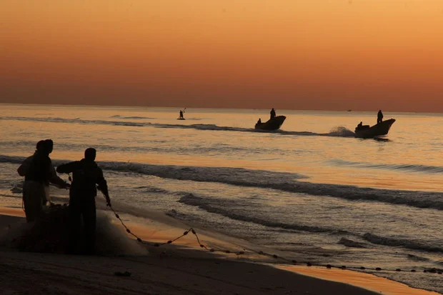 Palestinian fishermen are seen working at sunrise at the port of Gaza City. Fishing is a crucial livelihood for many Palestinians living in the impoverished territory. february 11, 2010. Photo by Wissam Nassar/FLASH90