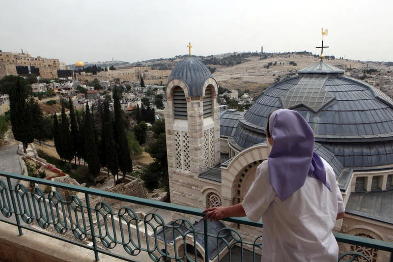 A woman looking at the view of Mount Olives and the Dome of the Rock while standing next to the Saint Peter Church in Gallicantu, on Mount Zion, Jerusalem. May 18 2010. Photo by Yossi Zamir/Flash90.