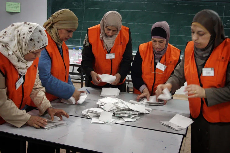 Palestinian poll officials tally the votes at a polling station in the West Bank city of Ramallah on October 20, 2012. Polling stations were closed in the West Bank after 12 hours of voting in the first Palestinian election since 2006, with voters casting their ballots in a municipal poll which was boycotted by the Hamas. Photo by Issam Rimawi/FLASH90