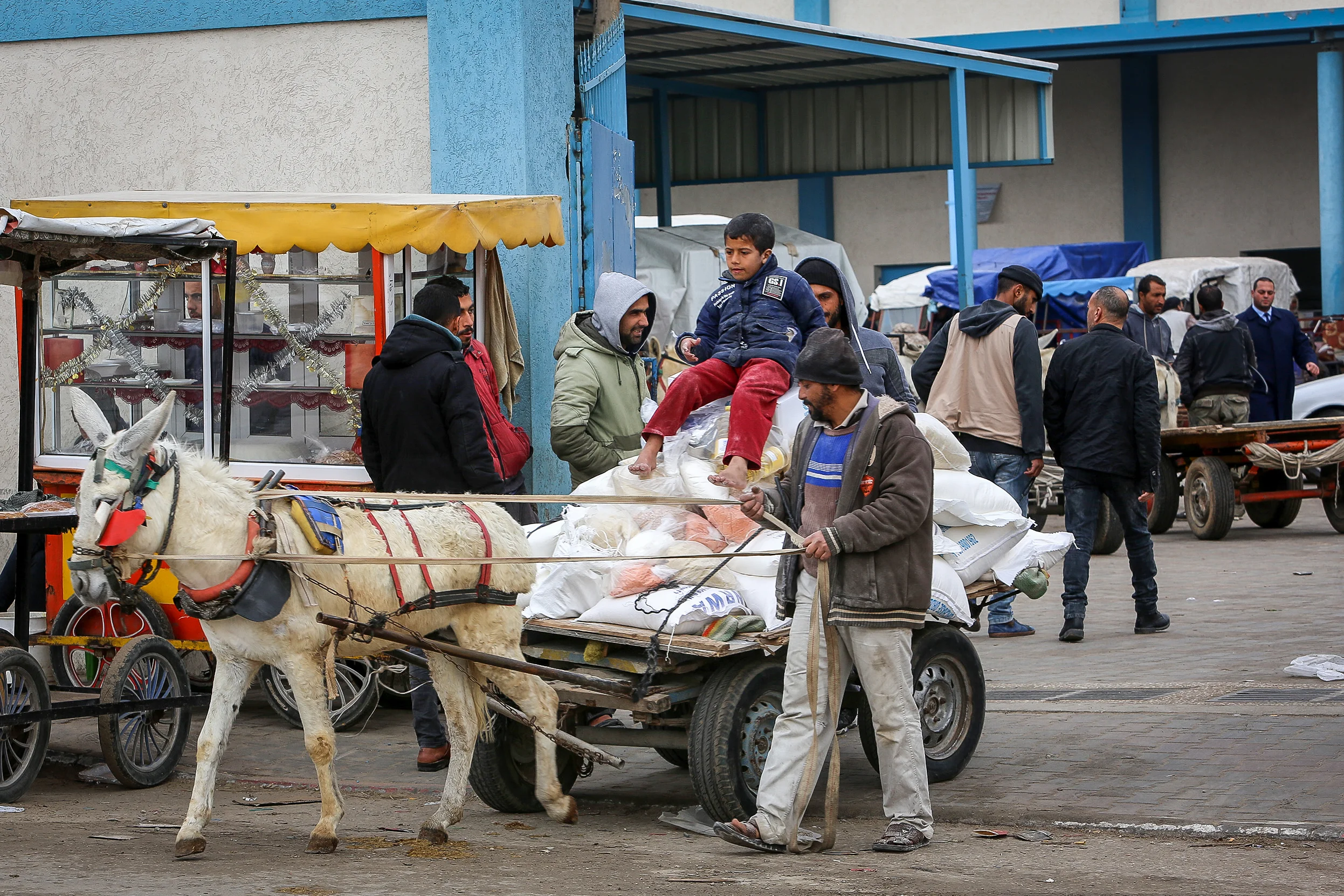 Palestinians receive food aid at a United Nations distribution center (UNRWA) in the southern Gaza Strip town of Rafah, on January 13, 2020. Photo by Abed Rahim Khatib/Flash90
