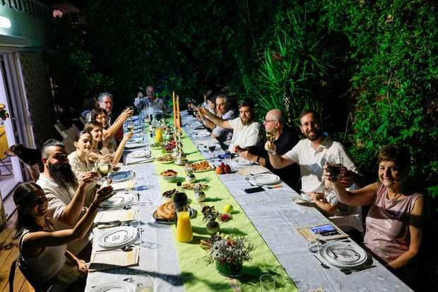 A Jewish family celebrates together on the eve of Rosh Hashana, the Jewish New Year, on October 2, 2024, in Rananna. Photo by Nati Shohat/Flash90