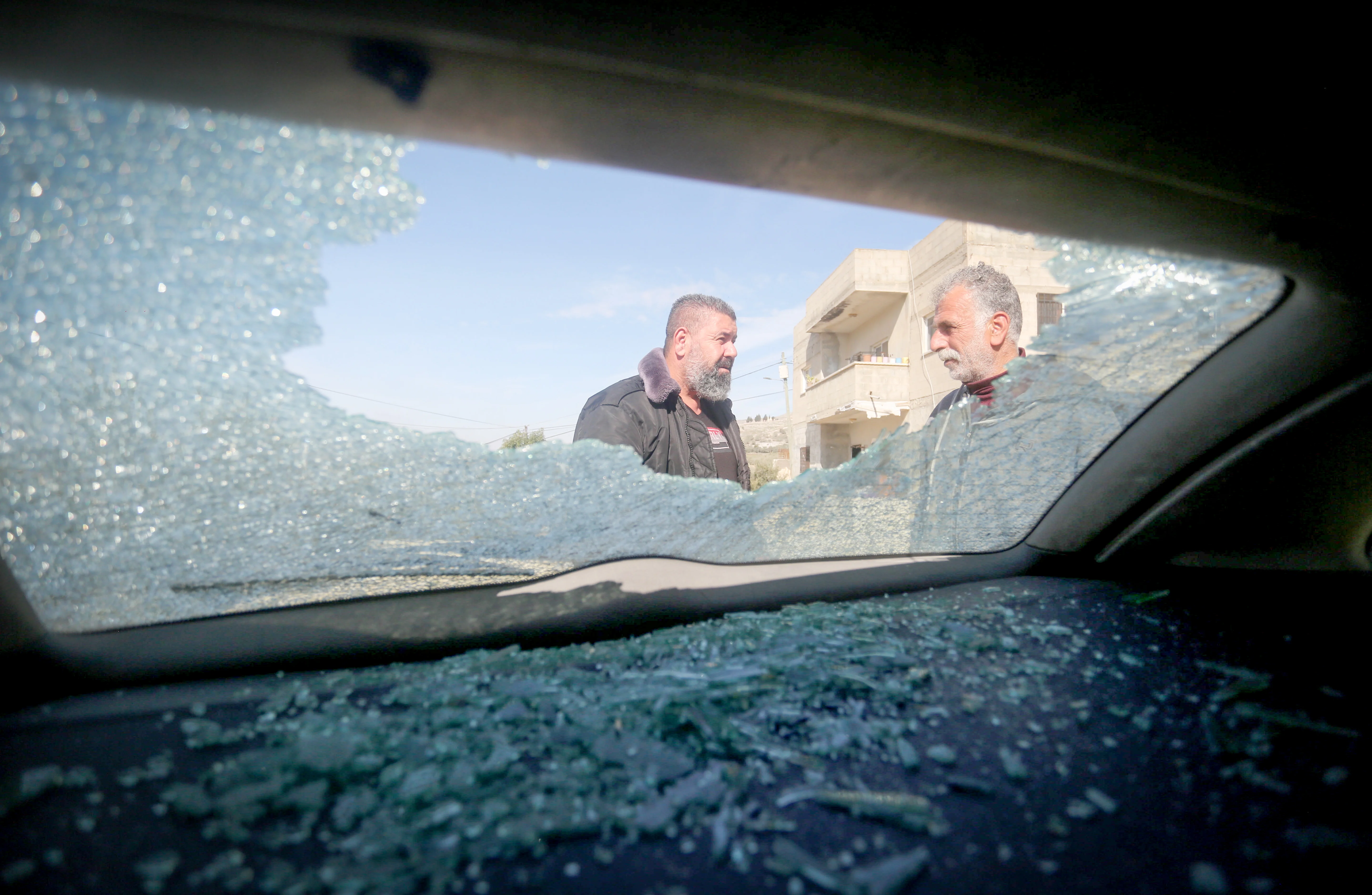 Palestinians inspect a car set ablaze by settlers overnight in the village of Burin near the Yitzhar settlement south of Nablus in the West Bank, after Palestinians celebrated a ceasefire between Israel and Hamas in Gaza on January 16, 2025.. Photo by Nasser Ishtayeh/Flash90