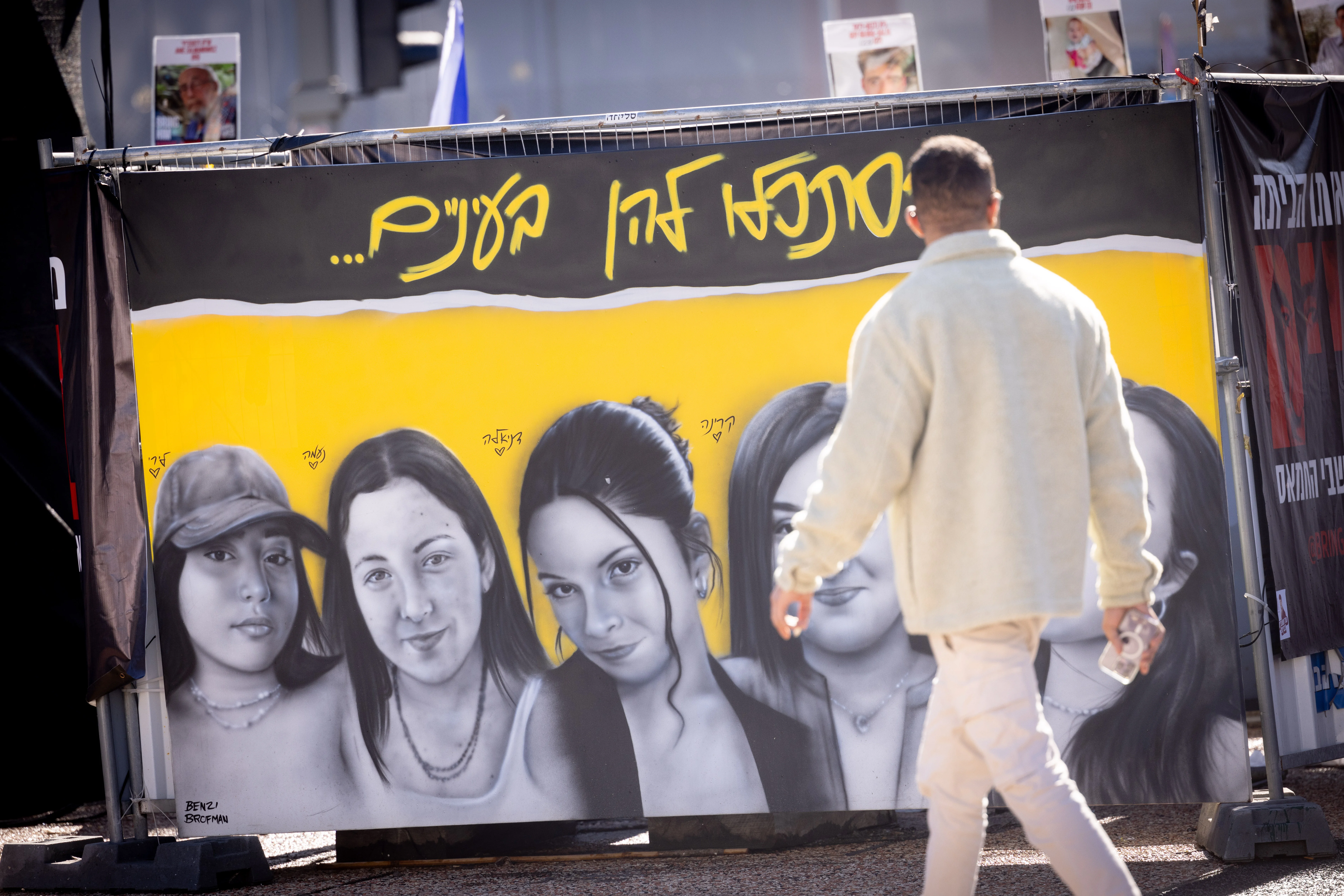 Visitors at Hostage Square in Tel Aviv. Pictures show captured IDF soldiers Liri Albag, Naama Levy, Danielle Gilboa, Karina Ariev (Left to right). January 23, 2025. Photo by Miriam Alster/FLASH90