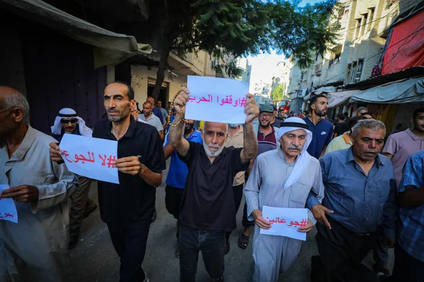 Palestinians calling for an end to violence and the entry of humanitarian aid on July 20, 2025, in the central Gaza Strip. Photo by Ali Hassan/Flash90