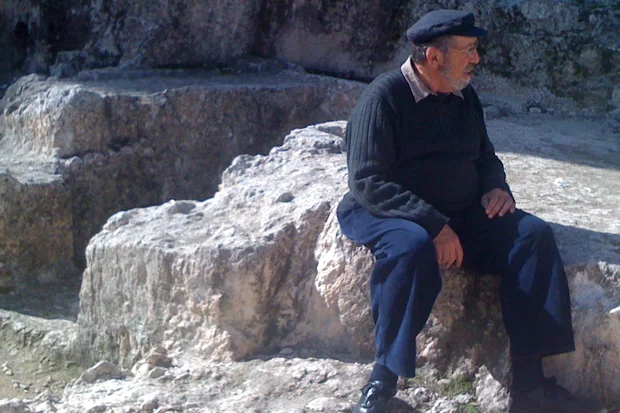 Gabriel Barkay at Ketef Hinnom, sitting on top of the cave where he discovered the silver plaques containing the priestly benediction from the Book of Numbers, December 25, 2009 Photo: Wikimedia Commons