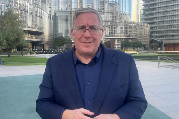 Joel C. Rosenberg stand in front of Dubai's Burj Khalifa in the United Arab Emirates