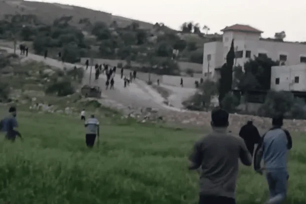 Jewish settlers attack the Palestinian village of Duma, southeast of Nablus. Photo: Screenshot from social media footage.