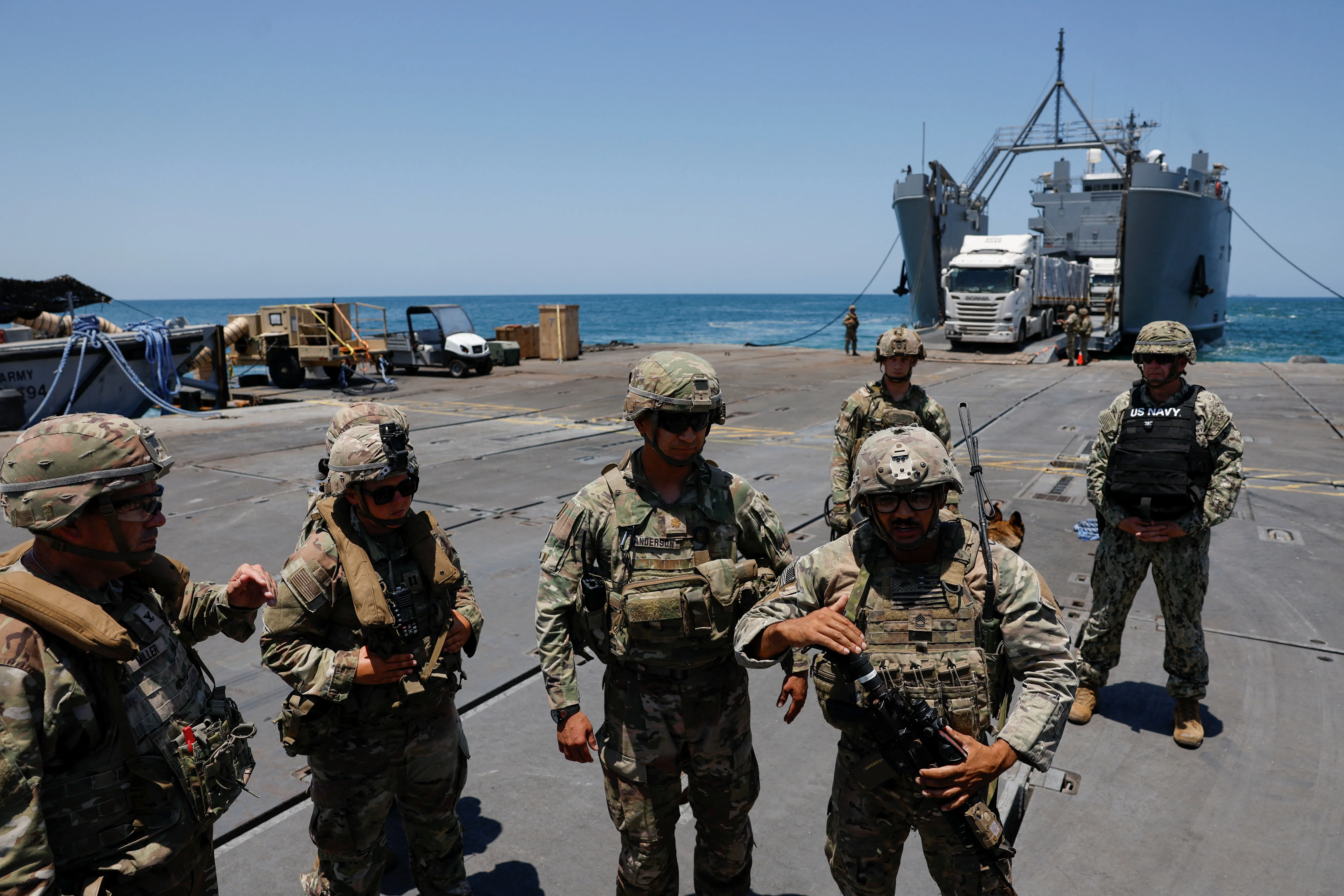 Soldiers stand at Trident Pier, a temporary pier to deliver aid, off the Gaza Strip, amid the ongoing conflict between Israel and Hamas, near the Gaza coast, June 25, 2024. REUTERS/Amir Cohen