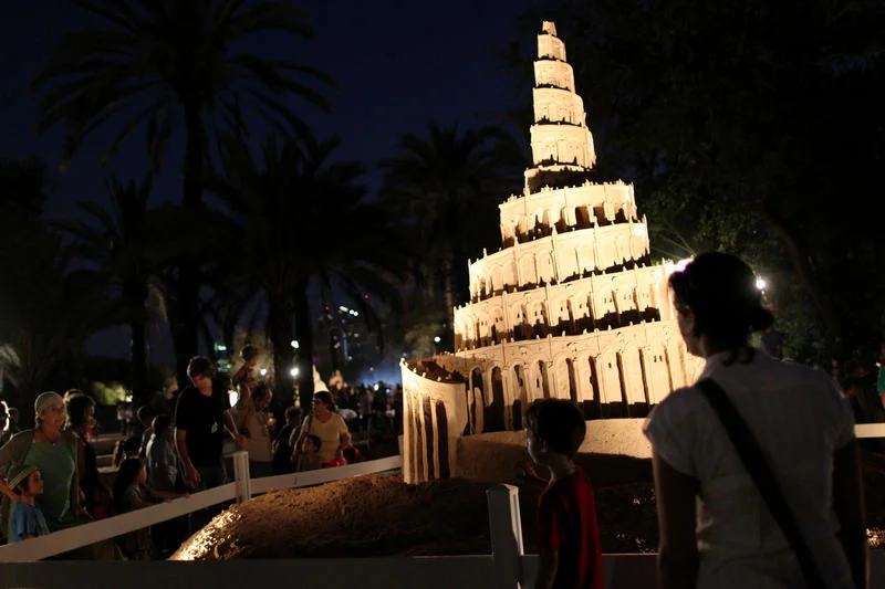 Israelis look at a sculpture made of sand of the 