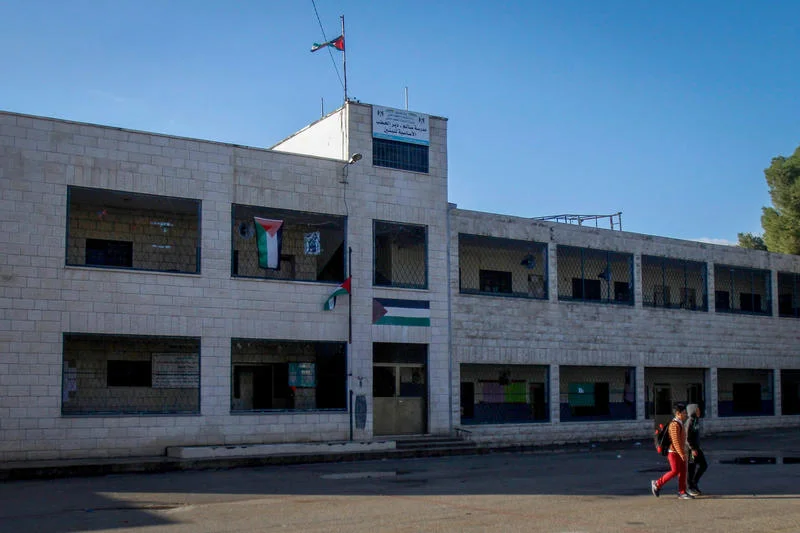 Palestinian school boys outside a closed school in the West Bank town of Nablus