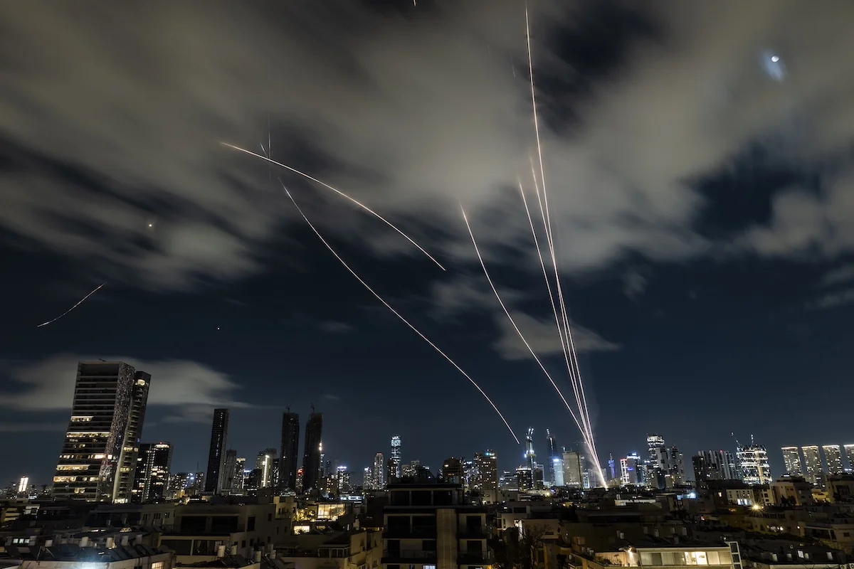 Anti-missile batteries fire interception missiles toward incoming ballistic missiles launched from Iran