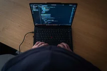 Person using a laptop displaying code