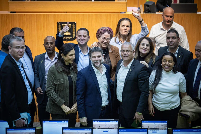 Finance Minister Bezalel Smotrich, Justice Minister Yariv Levin and Knesset Members celebrate