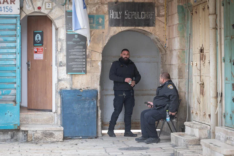 Police officers guard outside the Church of the Holy Sepulchre in the Old City of Jerusalem