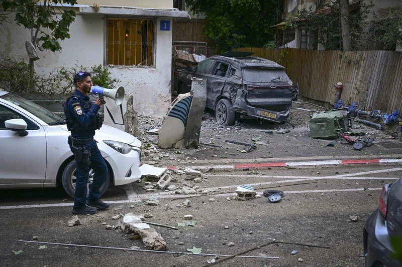 Israeli security and rescue forces at the scene where a missile fired from Iran toward Israel