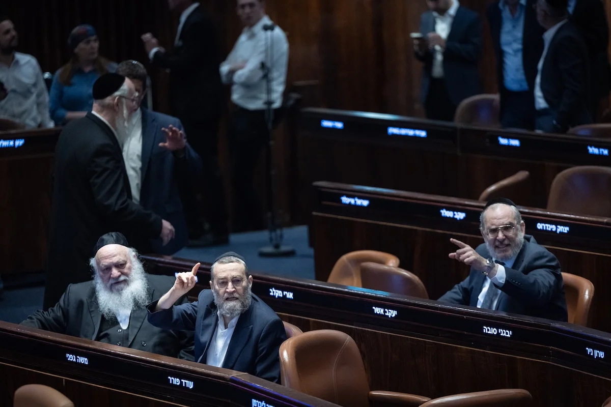 MK Moshe Gafni (center) reacts during a plenum session at the assembly hall of the Knesset